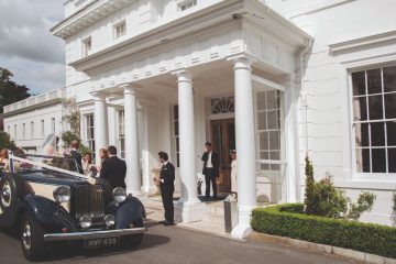 A photo outside henley reception building with wedding car